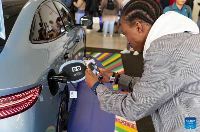 A visitor takes photos of an electric vehicle of BYD from China during the Festival of Motoring in Johannesburg, South Africa, Aug. 30, 2024. This event is held here from Aug. 30 to Sept. 1. Photo: Xinhua