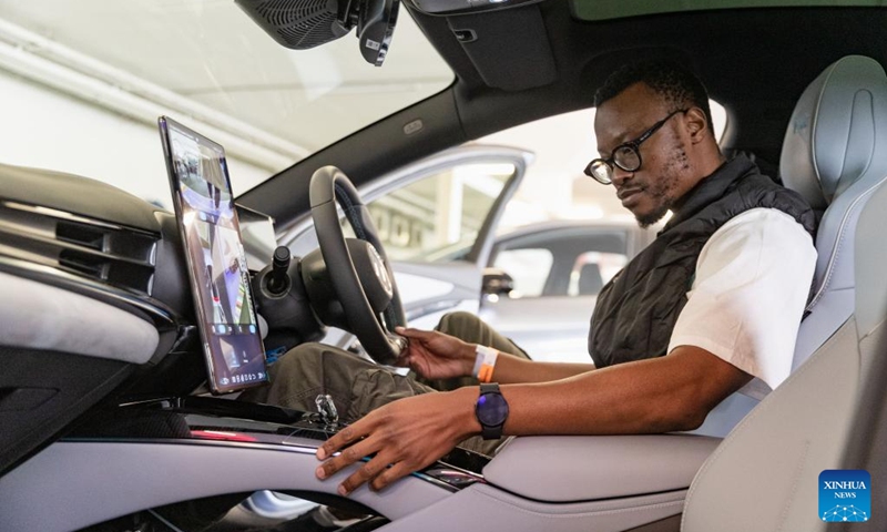 A visitor tries an electric vehicle of BYD from China during the Festival of Motoring in Johannesburg, South Africa, Aug. 30, 2024. This event is held here from Aug. 30 to Sept. 1. Photo: Xinhua