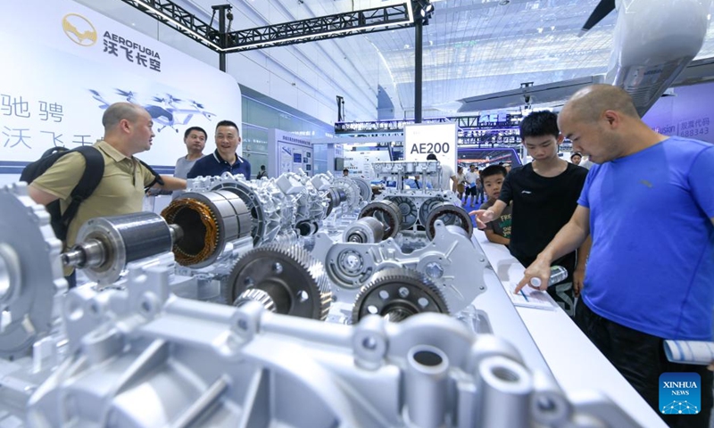 Visitors learn about a 800V dual-motor drive system for the new energy vehicle (NEV) at an exhibition on the sidelines of the 2024 World Power Battery Conference in Yibin, southwest China's Sichuan Province, Sept. 1, 2024. (Photo: Xinhua)