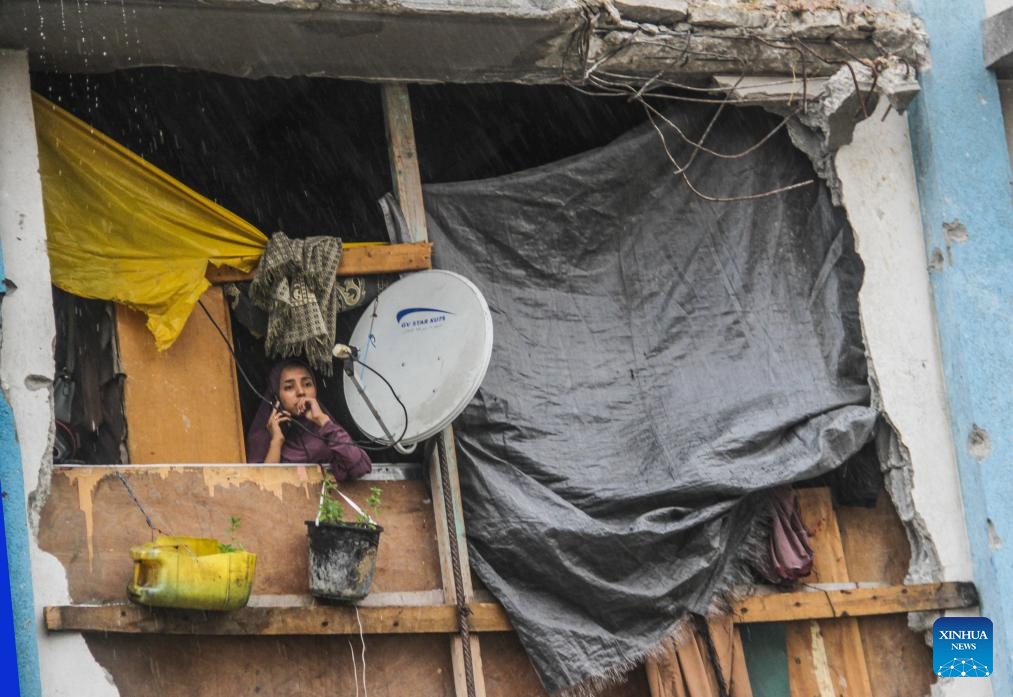 A woman looks out of her house in the rain in Jabalia refugee camp in the northern Gaza Strip, Sept. 1, 2024. (Photo: Xinhua)