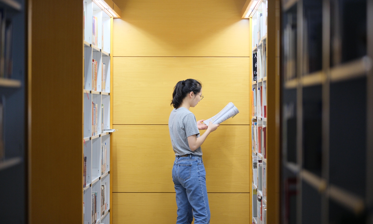 A woman reads in a library in Nantong, East China's Jiangsu Province, on August 12, 2024.  Photo: VCG