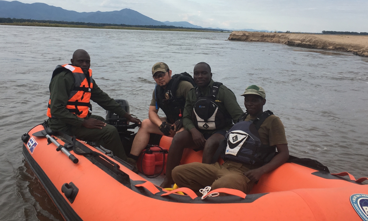 Bu Guijun (second from left) and local rangers use inflatable boats for water patrols in Zimbabwe. Photo: Courtesy of Bu Guijun