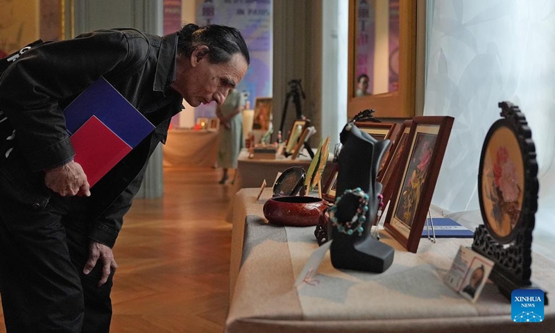 A visitor appreciates exhibits at the Beautiful Crafts Workshop, Blossoming in Paris exhibition of cultural and creative works by women with disabilities at Chinese Cultural Center in Paris, France, Sept. 3, 2024. (Photo: Xinhua)