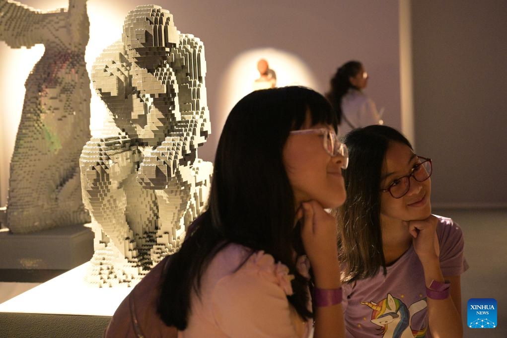 Children imitate the pose of an exhibit during the Art of the Brick exhibition at Singapore Expo in Singapore, Sept. 2, 2024. (Photo: Xinhua)