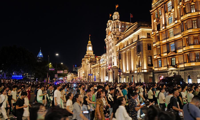 Tourists visit the Bund area in east China's Shanghai, July 22, 2024. (Photo by Yu Jiayi/Xinhua)