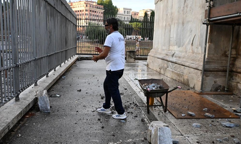 A man clear up the fragments falling from the Arch of Constantine in a thunderstorm in Rome, Italy, on Sept. 3, 2024. Italy has been battered by storms in the last few hours, with risk warnings issued for several regions on Wednesday, according to the country's Civic Protection Agency. The warning came after streets flooded in several cities on Tuesday, causing disruption to local transport. In Rome, the landmark Constantine Arch was damaged by lightning during a thunderstorm. (Photo: Xinhua)