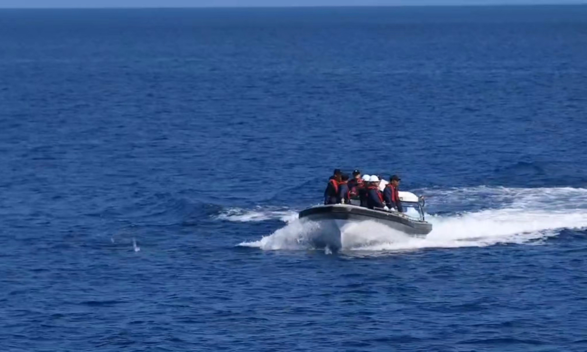 China Coast Guard personnel inspect a Vietnamese boat that illegally entered waters near China’s Xisha Islands on September 29, 2024.