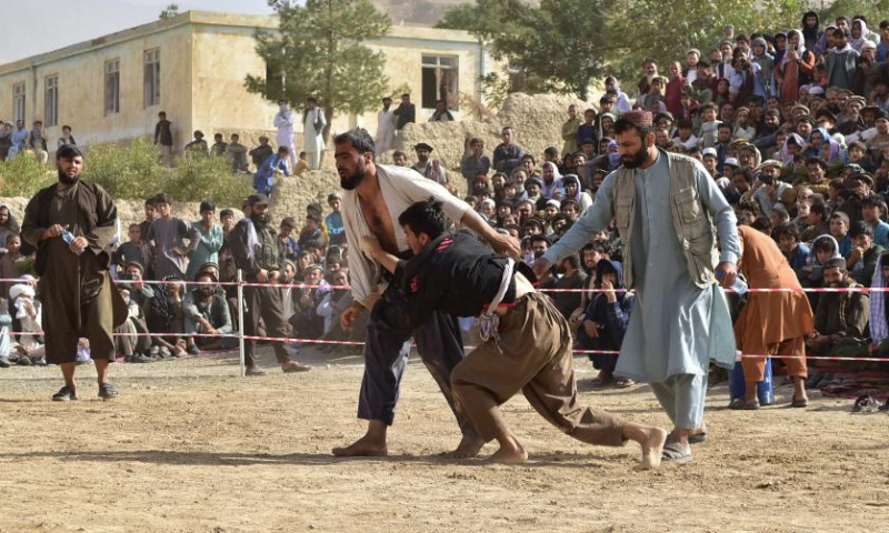 This photo taken on Sept. 8, 2024 shows people participating in a traditional wrestling contest in Nahrin district, north Afghanistan's Baghlan province. Wrestling, a traditional sport with deep roots in Afghan culture, remains popular across the country. In Baghlan province, wrestlers from Baghlan, Kunduz, Takhar and Samangan provinces competed in a thrilling tournament. Dozens of athletes participated, with thousands of spectators gathering to attentively witness this time-honored sport. (Photo by Mehrabuddin Ibrahimi/Xinhua)