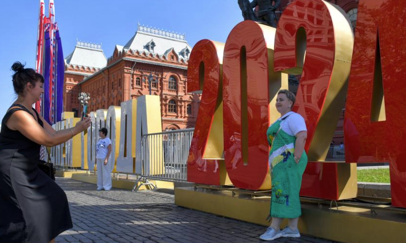 A woman poses for photos with an installation marking Moscow's 877th founding anniversary in Moscow, Russia, Sept. 8, 2024. A series of events were held on this weekend to celebrate Moscow City Day and to mark the city's 877th founding anniversary. (Photo by Alexander Zemlianichenko Jr/Xinhua)