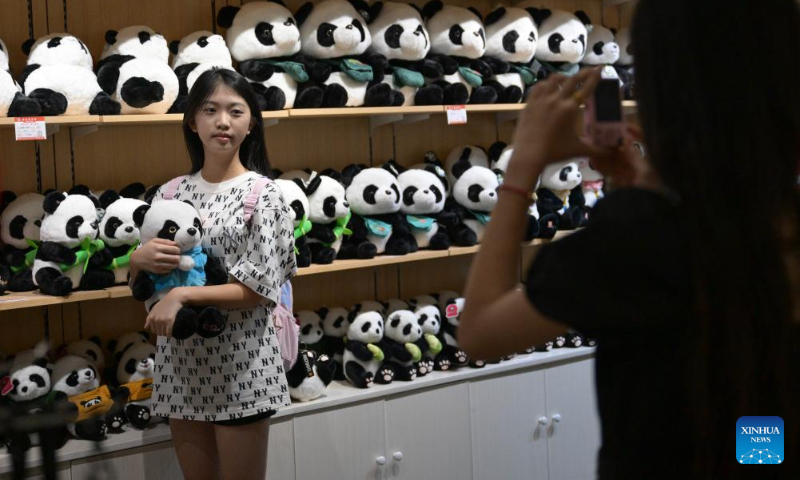 A tourist poses for photos at Hainan Tropical Wildlife Park and Botanical Garden in Haikou, south China's Hainan Province, Oct. 3, 2024. Exhibition areas of Hainan Tropical Wildlife Park and Botanical Garden were damaged in September due to the impact of Super Typhoon Yagi. Thanks to the restoration efforts for over 20 days, the wildlife park and botanical garden have been reopened to public recently. (Xinhua/Pu Xiaoxu)