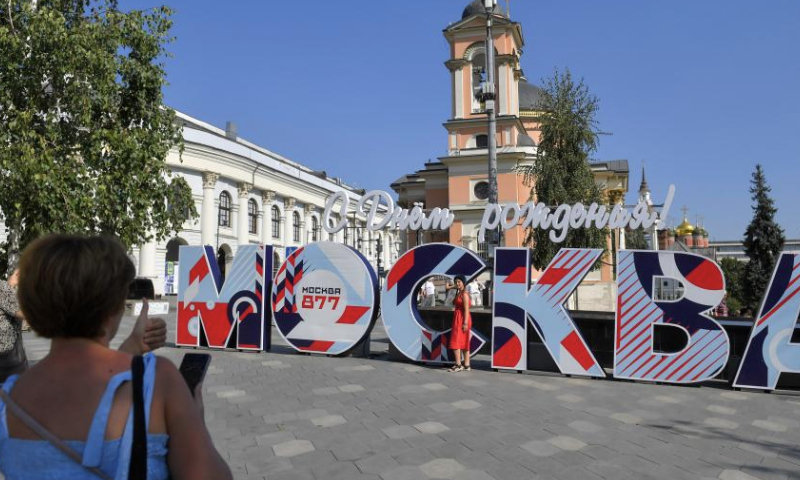 A woman poses for photos with an installation marking Moscow's 877th founding anniversary in Moscow, Russia, Sept. 8, 2024. A series of events were held on this weekend to celebrate Moscow City Day and to mark the city's 877th founding anniversary. (Photo by Alexander Zemlianichenko Jr/Xinhua)