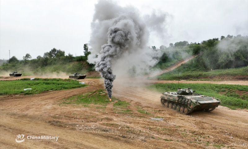 Armored vehicles attached to a brigade under the Chinese PLA 79th Group Army pass through the mock enemy's artillery barrage during a company-level tactic assessment in late July, 2024. (eng.chinamil.com.cn/Photo by Wang Lijun)