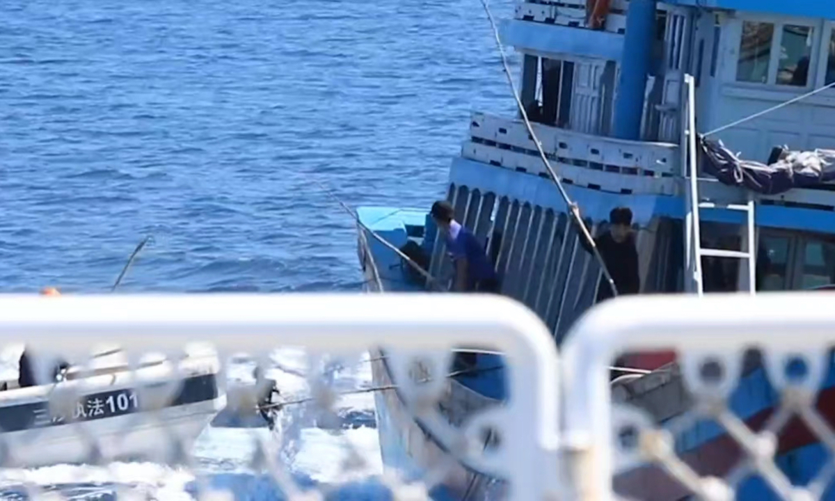 China Coast Guard personnel inspect a Vietnamese boat that illegally entered waters near China’s Xisha Islands on September 29, 2024.