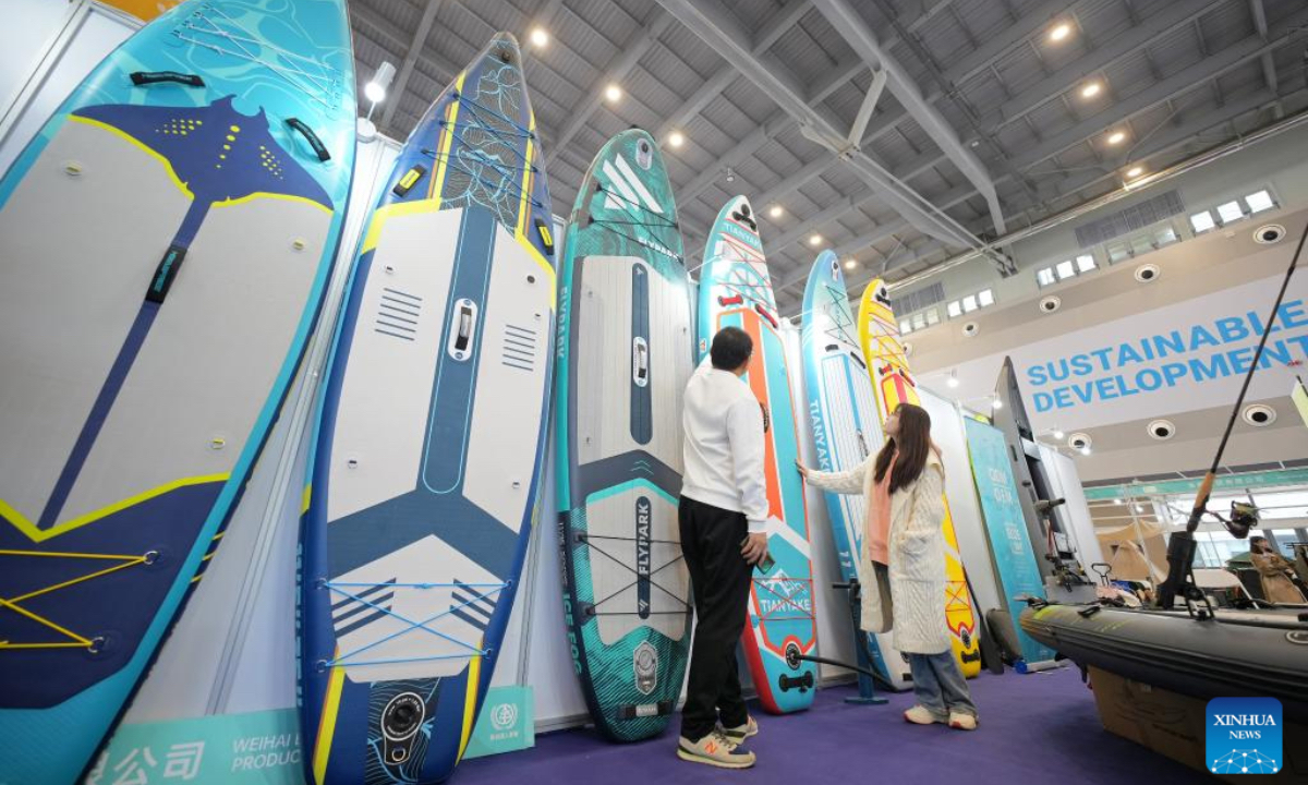 Visitors learn about outdoor sports equipment at an exhibition of the 2024 World Cities Day China Observance in Weihai, east China's Shandong Province, Oct. 26, 2024. More than 2000 delegates from over 30 countries and regions attended the event. (Photo: Xinhua)