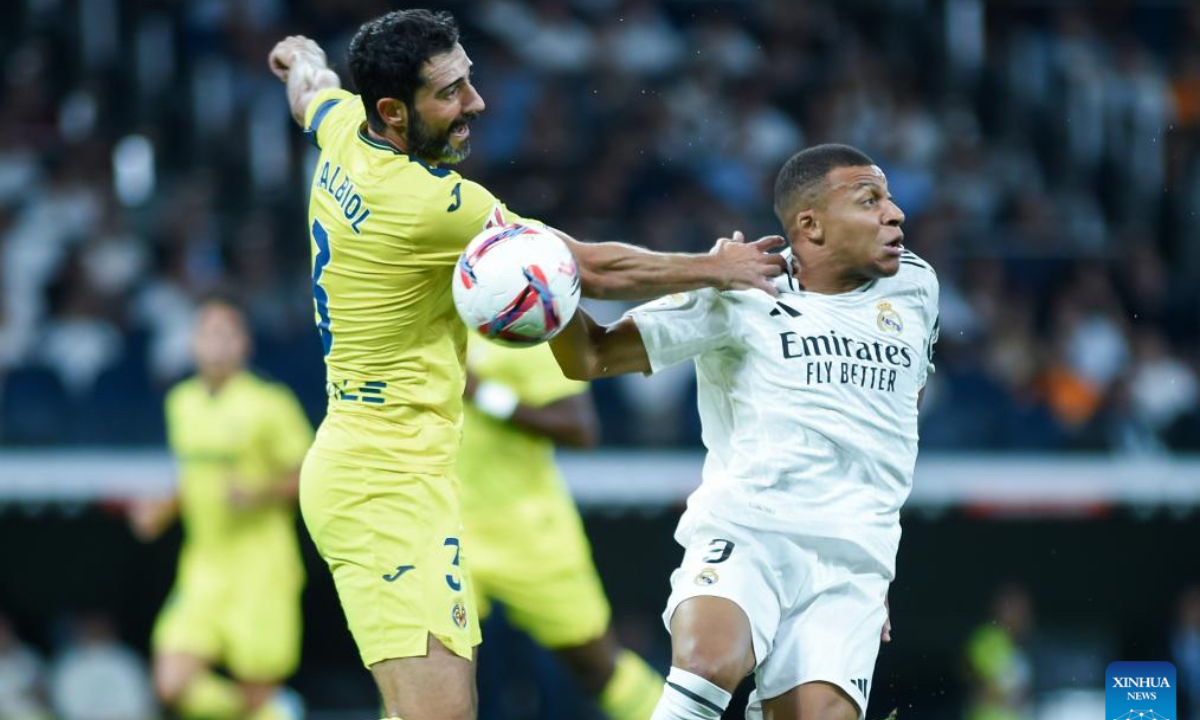 Kylian Mbappe (R) of Real Madrid vies with Raul Albiol of Villarreal during the La Liga football match between Real Madrid and Villarreal in Madrid, Spain, on Oct. 5, 2024. (Photo: Xinhua)