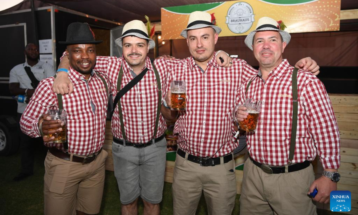 People enjoy beer at the Windhoek Oktoberfest in Windhoek, Namibia, Oct. 25, 2024. The 64th edition of the Windhoek Oktoberfest kicked off on Friday in the Namibian capital of Windhoek. (Photo: Xinhua)