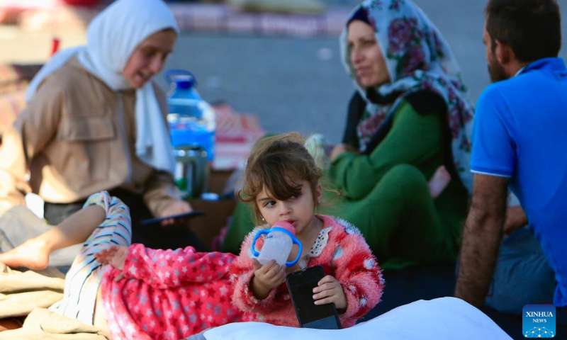 Displaced people live at a parking lot in Sidon, Lebanon on Oct. 3, 2024. (Photo by Ali Hashisho/Xinhua)