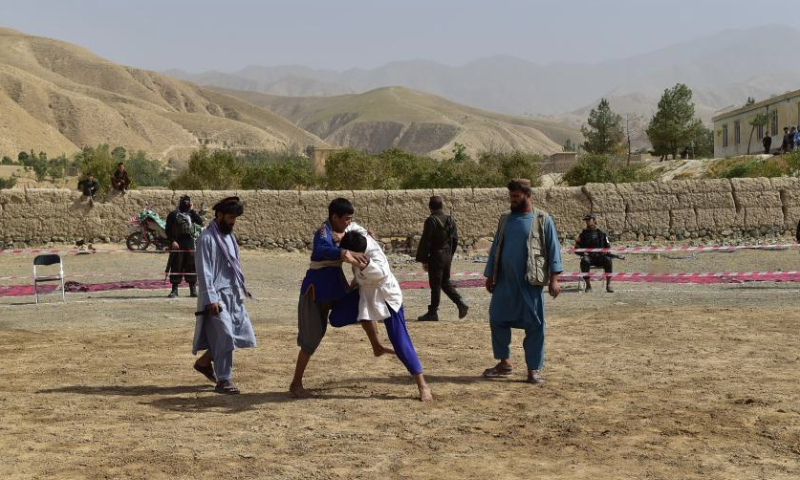 This photo taken on Sept. 8, 2024 shows people participating in a traditional wrestling contest in Nahrin district, north Afghanistan's Baghlan province. Wrestling, a traditional sport with deep roots in Afghan culture, remains popular across the country. In Baghlan province, wrestlers from Baghlan, Kunduz, Takhar and Samangan provinces competed in a thrilling tournament. Dozens of athletes participated, with thousands of spectators gathering to attentively witness this time-honored sport. (Photo by Mehrabuddin Ibrahimi/Xinhua)