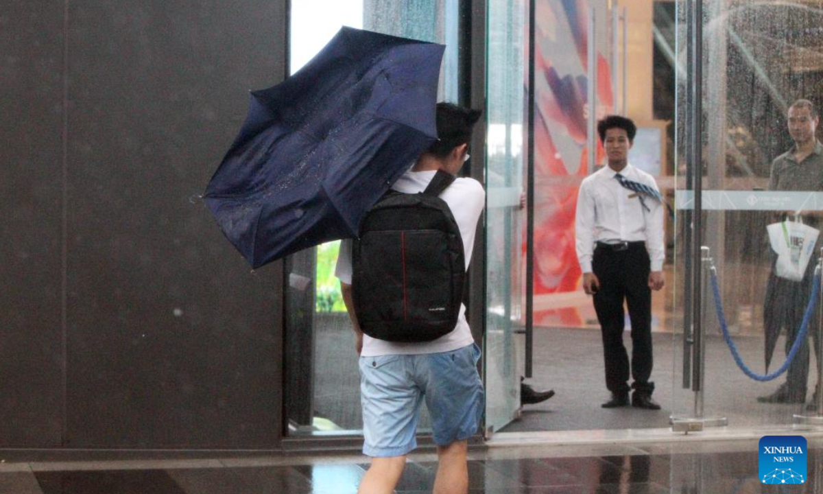 A man walks upwind to a shopping mall in east China's Shanghai, Sep 16, 2024. Photo:Xinhua