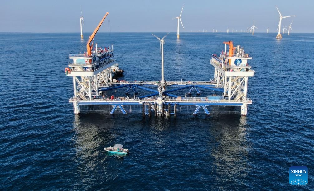 An aerial drone photo taken on Sept. 2, 2024 shows China General Nuclear Power Corporation (CGN)'s Fuxi No. 1 wind power-fishery integrated project in Shanwei, south China's Guangdong Province. Using green energy as its power supply, the marine ranch project started its operation in Shanwei on Sept. 4. It is expected to produce 900 tonnes of high-quality marine fish annually. (Photo: Xinhua)