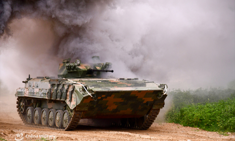 An armored vehicle attached to a brigade under the Chinese PLA 79th Group Army passes through the mock enemy's artillery barrage during a company-level tactic assessment in late July, 2024. (eng.chinamil.com.cn/Photo by Wang Lijun)