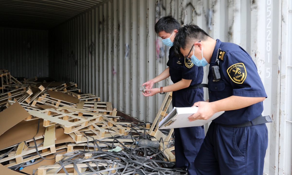 The local customs officials imposed a customs seal and lawfully returned a container with 150 kilograms of prohibited imported solid waste from a container terminal in Zhoushan, East China's Zhejiang Province, on June 24, 2020. Photo: VCG