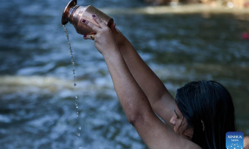 A Hindu woman performs a ritual in the Bagmati River during Rishi Panchami festival in Kathmandu, Nepal, Sept. 8, 2024. Rishi Panchami festival marks the end of the three-day Teej festival when women worship Sapta Rishi (Seven Saints) and pray for health for their husband while unmarried women wish for handsome husband and happy conjugal lives. (Photo by Sulav Shrestha/Xinhua)