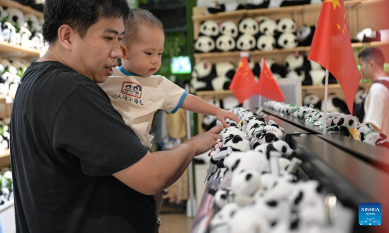 Tourists shop at a souvenir shop of Hainan Tropical Wildlife Park and Botanical Garden in Haikou, south China's Hainan Province, Oct. 3, 2024. Exhibition areas of Hainan Tropical Wildlife Park and Botanical Garden were damaged in September due to the impact of Super Typhoon Yagi. Thanks to the restoration efforts for over 20 days, the wildlife park and botanical garden have been reopened to public recently. (Xinhua/Pu Xiaoxu)