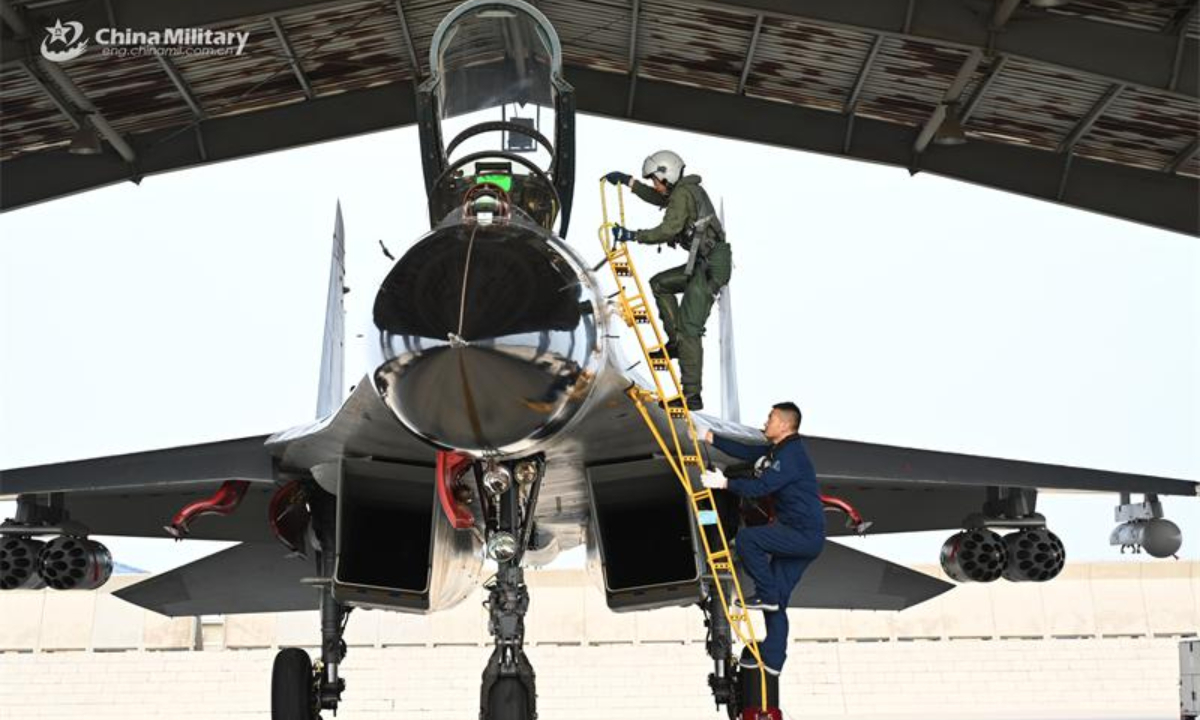 A pilot assigned to an aviation regiment under the Chinese PLA Air Force climbs into the cockpit to get ready for an air battle training exercise in early July, 2024. Photo:China Military