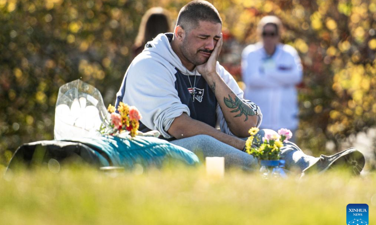 A man mourns the Lewiston Shooting victims in Lewiston, Maine, the United States on Oct. 25, 2024. This Friday marks the one year anniversary of the mass shooting in Lewison back in 2023. As many as 18 people were killed and 13 injured in the mass shooting. (Photo: Xinhua)