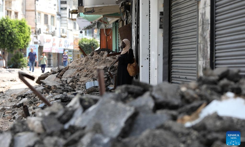 A woman looks at a damaged street after an Israeli raid in the West Bank city of Jenin, Sept. 4, 2024. Israel's military operations across the West Bank starting from Aug. 28 have caused great damages and casualties (Photo: Xinhua)