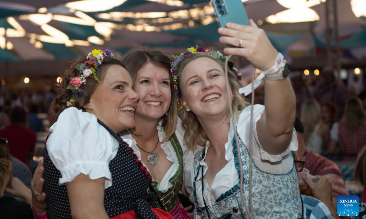 People take selfies at the Windhoek Oktoberfest in Windhoek, Namibia, Oct. 25, 2024. The 64th edition of the Windhoek Oktoberfest kicked off on Friday in the Namibian capital of Windhoek. (Photo: Xinhua)