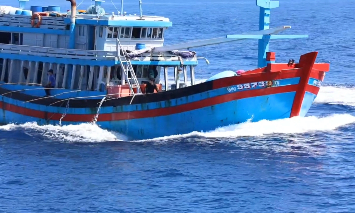 China Coast Guard personnel inspect a Vietnamese boat that illegally entered waters near China’s Xisha Islands on September 29, 2024.