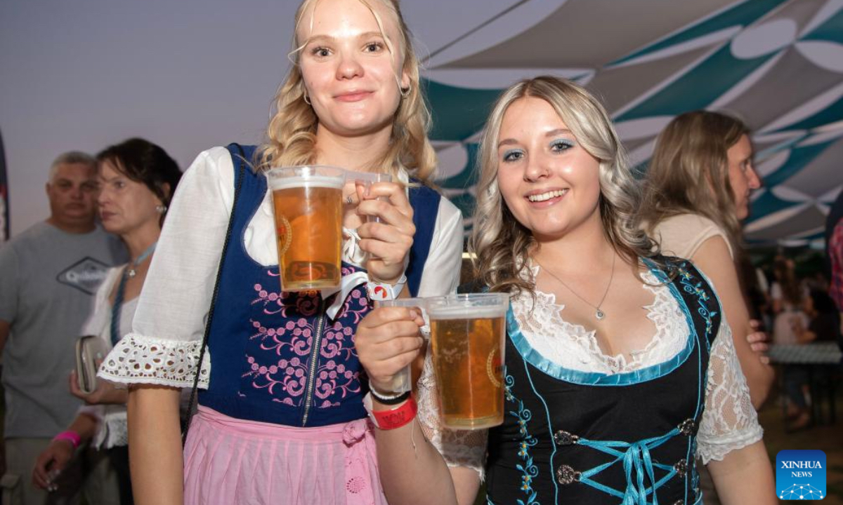 People enjoy beer at the Windhoek Oktoberfest in Windhoek, Namibia, Oct. 25, 2024. The 64th edition of the Windhoek Oktoberfest kicked off on Friday in the Namibian capital of Windhoek. (Photo: Xinhua)