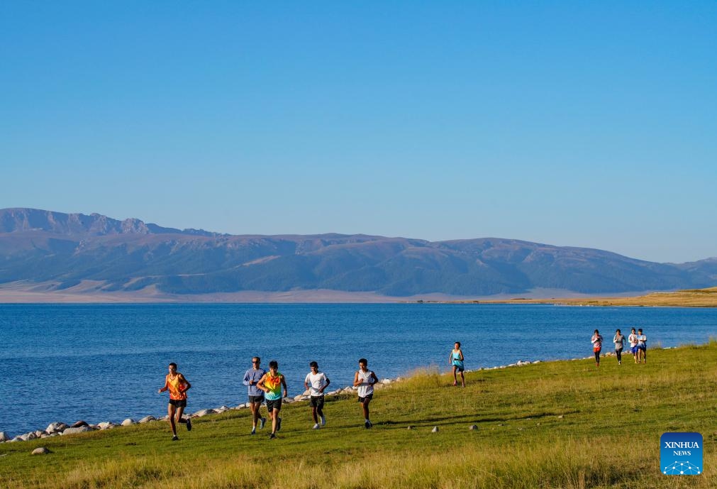 Runners of a local middle and long-distance running team attend a training session by the Sayram Lake in the Mongolian Autonomous Prefecture of Bortala, northwest China's Xinjiang Uygur Autonomous Region, Aug. 31, 2024. The team belongs to the Xinjiang disabled middle and long-distance running training base in the support of disabled persons federations at all levels. (Photo: Xinhua)