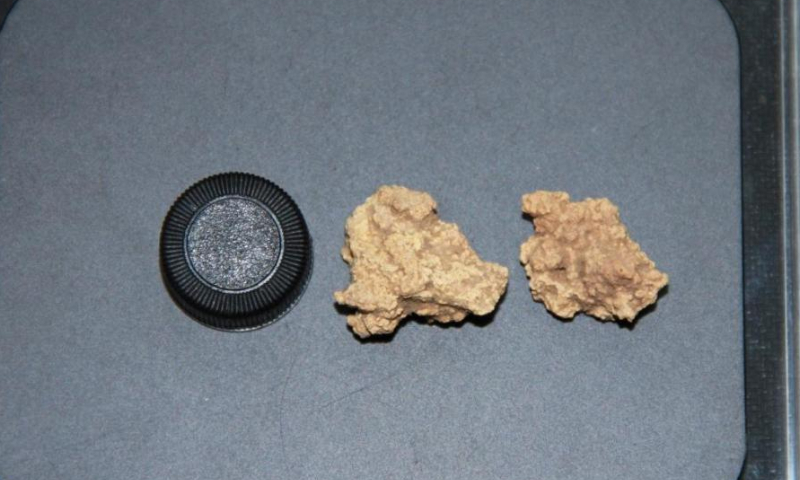 This undated file photo shows the comparison of a tube cap (L) and two Bronze Age cheese samples unearthed from a tomb site in northwest China's Xinjiang Uygur Autonomous Region. The 3,500-year-old mummies unearthed two decades ago in Xinjiang region captured global attention this week after scientists sequenced DNA from three cheese samples found at their burial site, revealing the secrets of the world's oldest known fermented dairy products. (Photo by Yang Yimin/Xinhua)