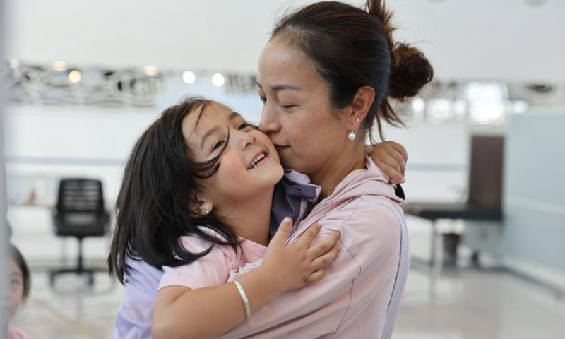 A girl evacuated from Lebanon embraces her mother at the Port of Limassol, Cyprus, on Oct. 1, 2024. (Xinhua/Li Jing)