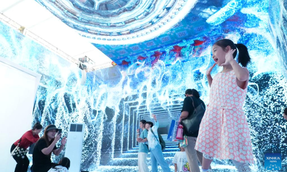 Visitors take photos at an immersive panoramic space during the 2024 China International Fair for Trade in Services (CIFTIS) in the Cultural & Tourism Service thematic exhibition area at the Shougang Park in Beijing, capital of China, Sep 16, 2024. Photo:Xinhua