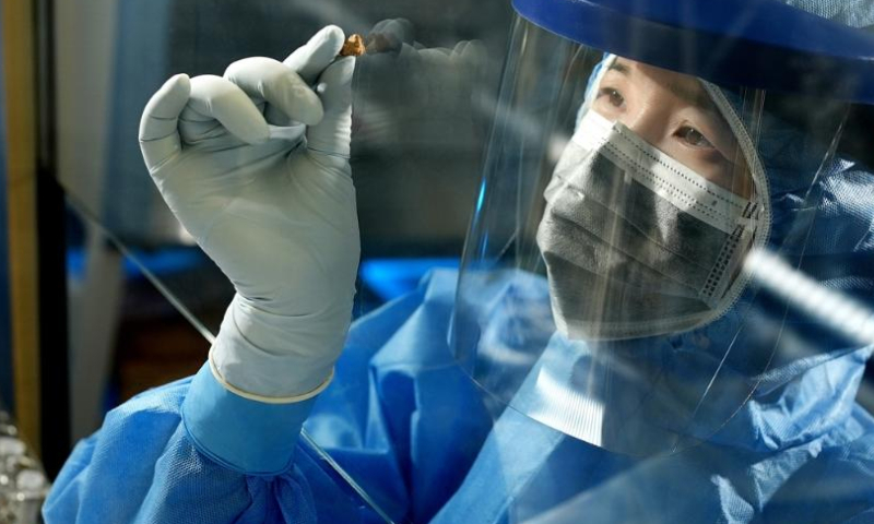 This undated file photo shows Fu Qiaomei, a world-renowned scientist from the Institute of Vertebrate Paleontology and Paleoanthropology of the Chinese Academy of Sciences (CAS), conducting experiments on an ancient cheese sample at the ultra-clean lab of the institute in Beijing, capital of China. The 3,500-year-old mummies unearthed two decades ago in Xinjiang region captured global attention this week after scientists sequenced DNA from three cheese samples found at their burial site, revealing the secrets of the world's oldest known fermented dairy products. (CAS/Handout via Xinhua)