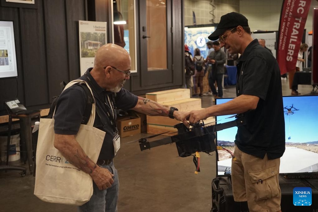 A man visits a booth at the Disasters Expo USA at the Los Angeles Convention Center in Los Angeles, California, the United States, on Sept. 5, 2024. Disasters Expo USA, the leading event mitigating the world's most costly disasters, kicked off on Thursday in Los Angeles, California, drawing thousands of disaster specialists, business owners and first responders from across the globe. (Photo: Xinhua)