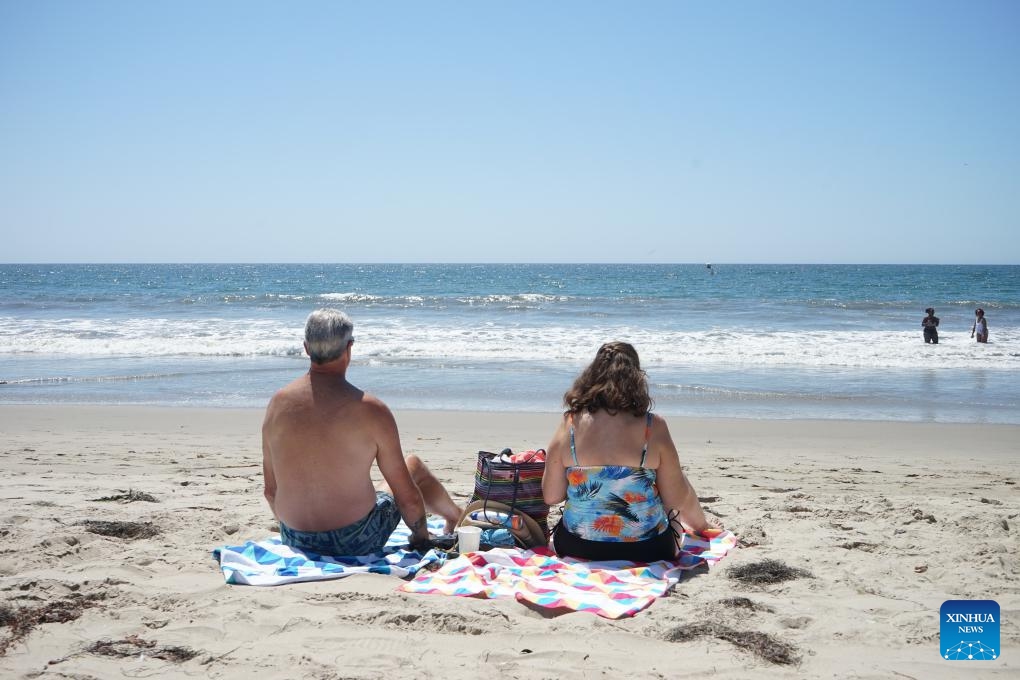 People sit at Santa Monica beach in Los Angeles, California, the United States, Sept. 4, 2024. As summer draws to a close, cities across the western United States are still reeling from unprecedented heatwaves that have shattered long-standing temperature records and pushed communities to their limits. (Photo: Xinhua)