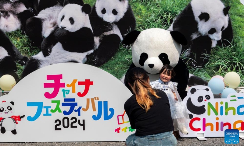 A woman takes a picture of her child with a giant panda doll during China Festival 2024 at Yoyogi Park in Tokyo, Japan, Sept. 7, 2024. China Festival 2024 kicked off in Yoyogi Park in downtown Tokyo on Saturday to promote people-to-people exchanges between China and Japan. Photo: Xinhua