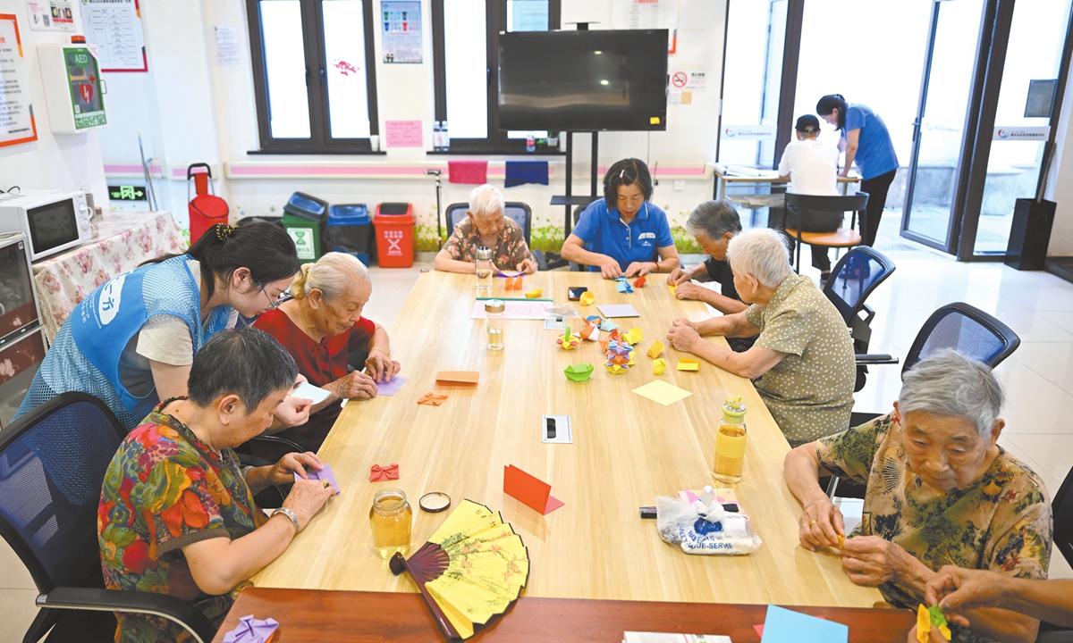 Elderly residents participate in a craft-making session at a local nursing home's day care program in Hangzhou, East China's Zhejiang Province, on August 28, 2024. Photo: VCG