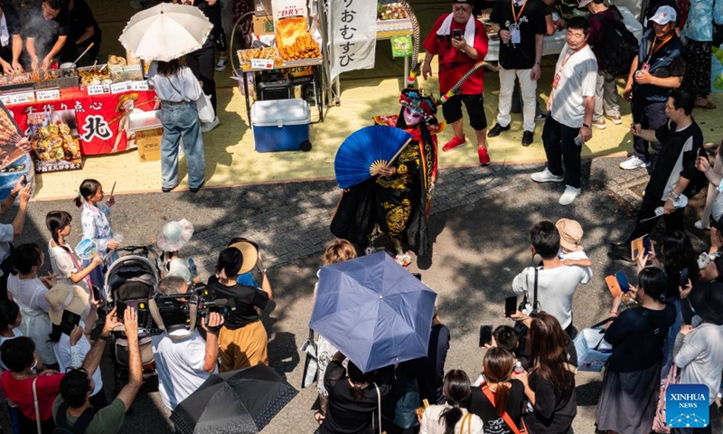 People watch a performance of Sichuan opera Bianlian, also known as face-changing, during China Festival 2024 at Yoyogi Park in Tokyo, Japan, Sept. 7, 2024. China Festival 2024 kicked off in Yoyogi Park in downtown Tokyo on Saturday to promote people-to-people exchanges between China and Japan. Photo: Xinhua