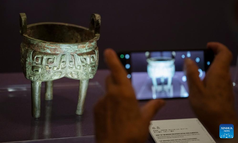 A visitor takes photos at an exhibition The Splendor of Chinese Bronzes: Masterpieces from the National Museum of China at Macao Museum of Art in Macao, south China, Sept. 6, 2024. The exhibition kicked off on Friday in Macao, showcasing more than 150 ancient bronzes from the collection of the National Museum of China. Photo: Xinhua