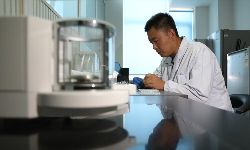 Wang Zhen weighs an animal sample in the Liaoning Ocean and Fisheries Science Research Institute in Dalian, northeast China's Liaoning Province, Sept. 6, 2024. Photo: Xinhua