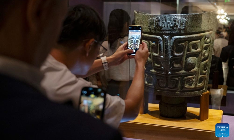 A visitor takes photos at an exhibition The Splendor of Chinese Bronzes: Masterpieces from the National Museum of China at Macao Museum of Art in Macao, south China, Sept. 6, 2024. The exhibition kicked off on Friday in Macao, showcasing more than 150 ancient bronzes from the collection of the National Museum of China. Photo: Xinhua