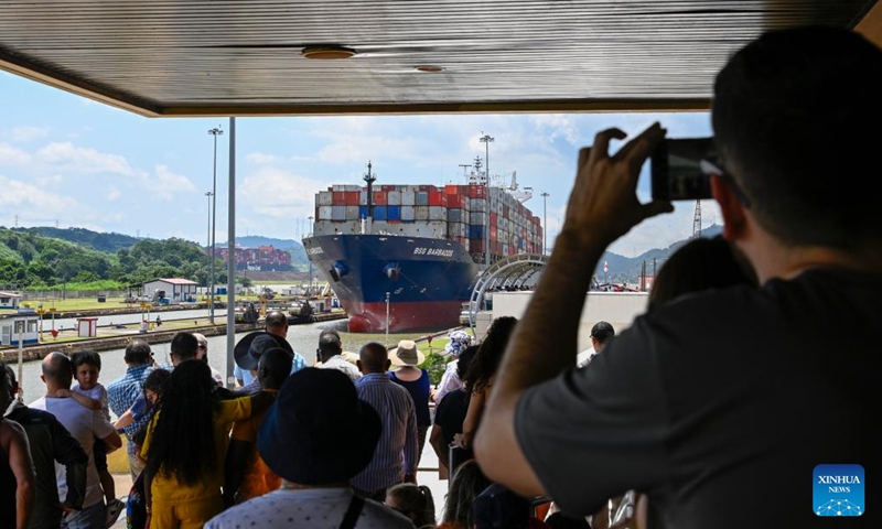 Visitors watch a cargo vessel sailing on the Panama Canal near Panama City, Panama, Aug. 28, 2024. The Panama Canal, connecting the Pacific and Atlantic Oceans, spans over 80 kilometers and is one of the world's most important trade waterways. The Panama Canal officially opened on Aug. 15, 1914. This year marks the 110th anniversary of its inauguration. Photo: Xinhua