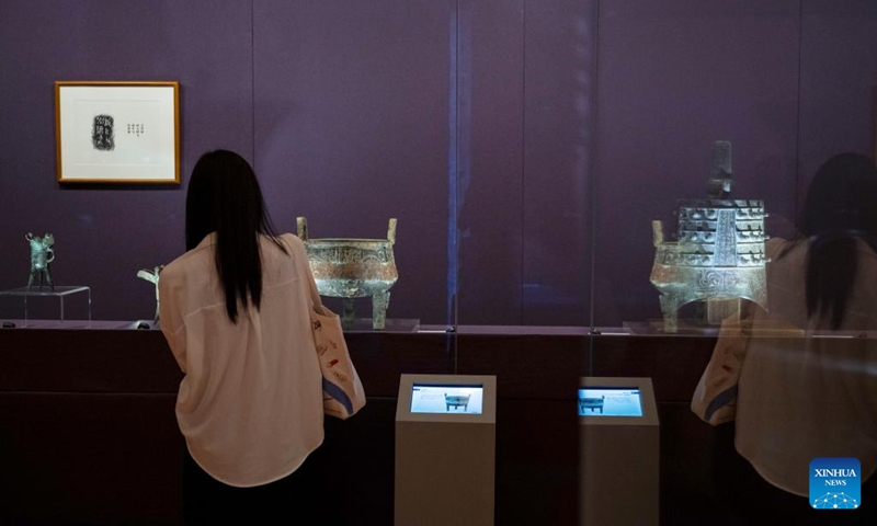 A visitor watches the exhibits at an exhibition The Splendor of Chinese Bronzes: Masterpieces from the National Museum of China at Macao Museum of Art in Macao, south China, Sept. 6, 2024. The exhibition kicked off on Friday in Macao, showcasing more than 150 ancient bronzes from the collection of the National Museum of China. Photo: Xinhua