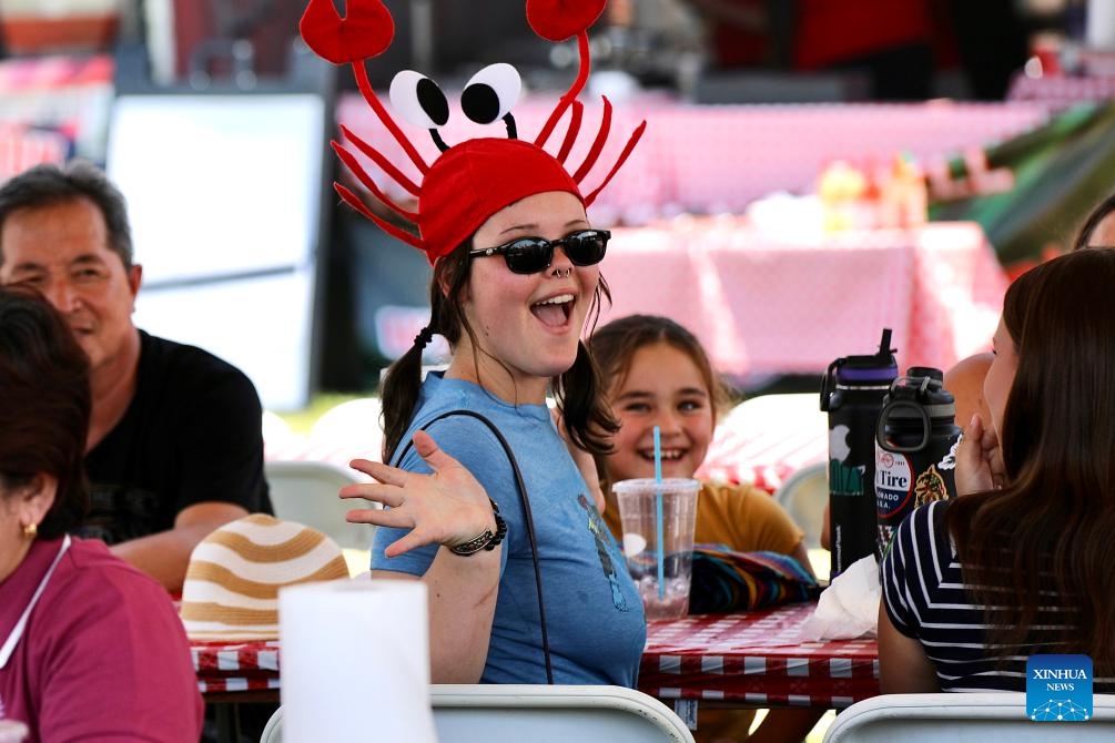 A woman wearing a lobster-shaped cap poses for a photo during the Original Lobster Festival in Fountain Valley, Orange County, California, the United States, Sept. 8, 2024. (Photo: Xinhua)